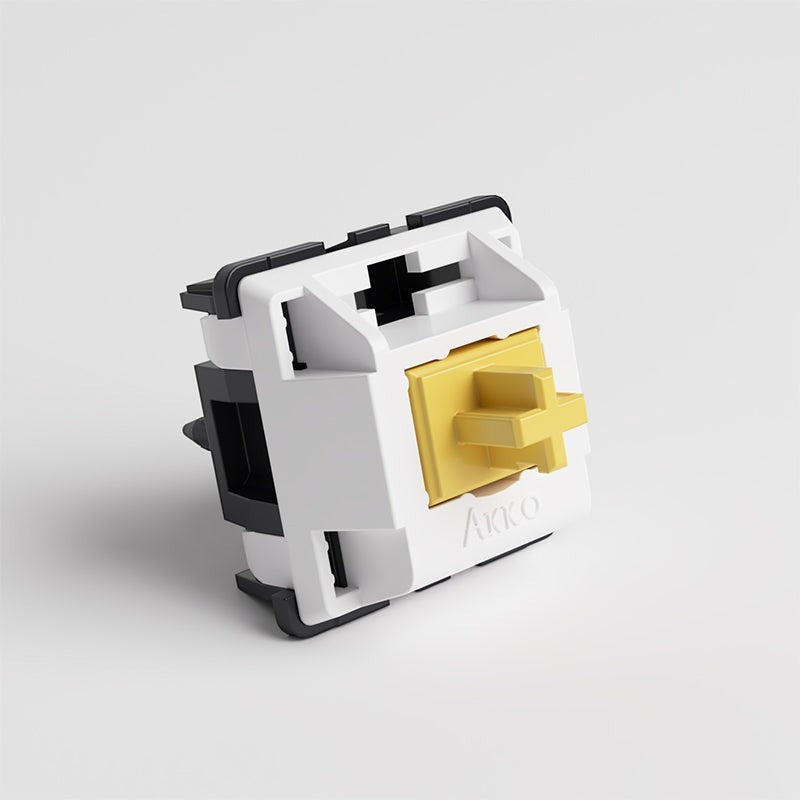 Switch táctil silencioso Akko Penguin con carcasa blanca y negra y vástago amarillo de MyKeyboard