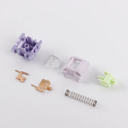 Componentes desmontados del switch lineal MyKeyboard EPOMAKER Wisteria V2 en tonos lila, verde y metal