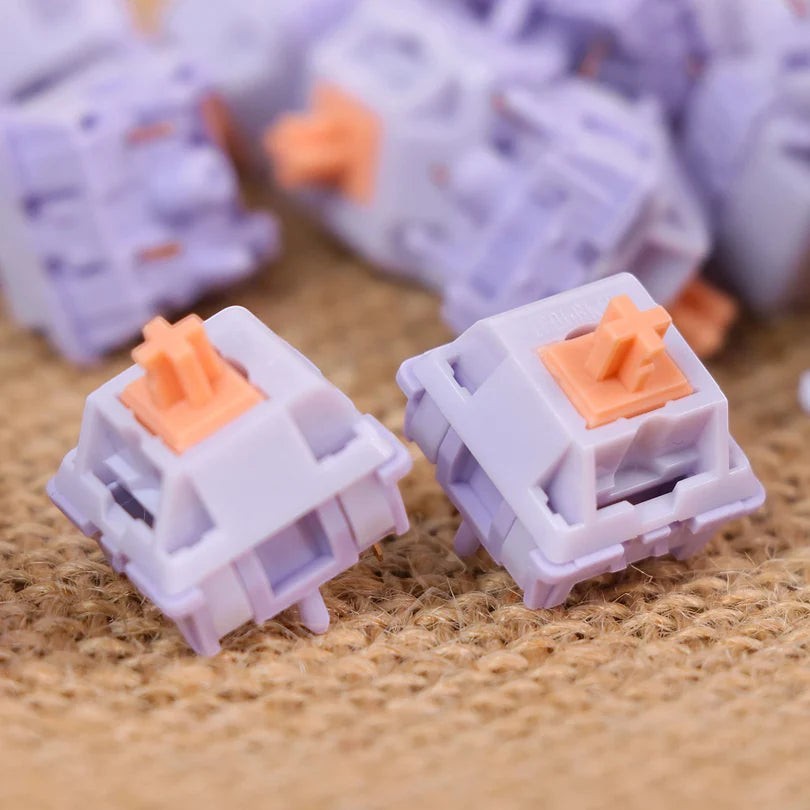 Switches táctiles MyKeyboard EPOMAKER Wisteria de color lila con stem naranja, ideales para teclados mecánicos.